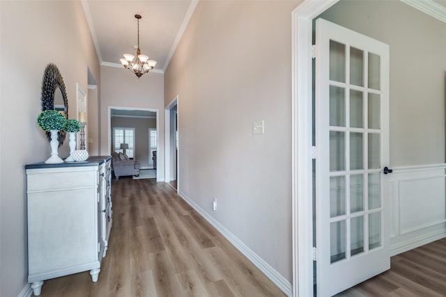 1908 Thompson Ct, Flower Mound, TX 75028 - hallway with ornamental molding, a chandelier, and light wood-style floors
