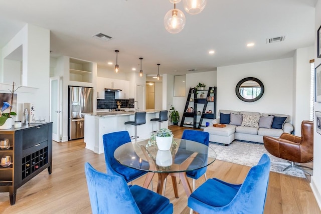 4333 Gilbert Ave Unit 329, Dallas, TX 75219 - dining room with light wood-style flooring and recessed lighting