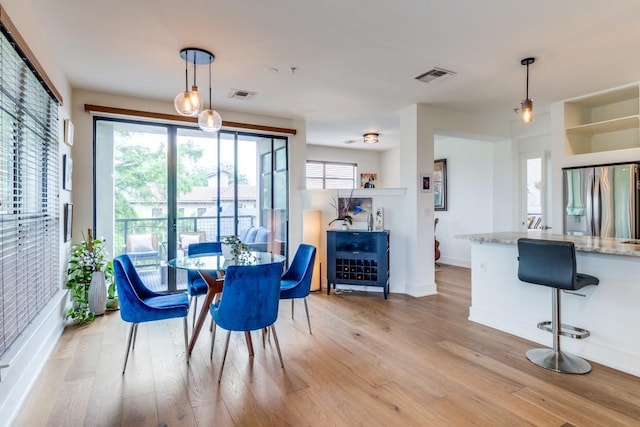 4333 Gilbert Ave Unit 329, Dallas, TX 75219 - dining room with light wood-type flooring and baseboards