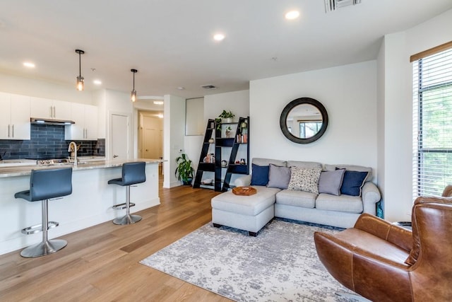 4333 Gilbert Ave Unit 329, Dallas, TX 75219 - living room featuring light wood finished floors, recessed lighting, and baseboards
