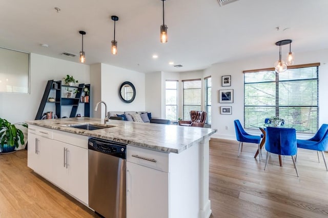 4333 Gilbert Ave Unit 329, Dallas, TX 75219 - kitchen with stainless steel dishwasher, a sink, light wood-type flooring, decorative light fixtures, and recessed lighting