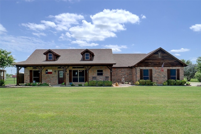 12210 Hill Country Cir, Ponder, TX 76259 - view of front facade with a front yard, brick siding, roof with shingles, and a porch
