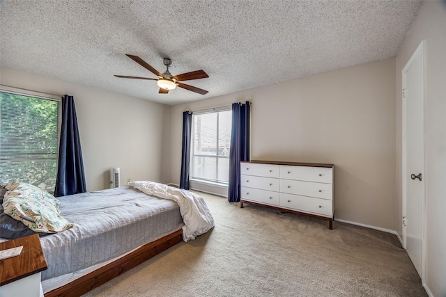12834 Midway Rd Unit 1105, Dallas, TX 75244 - bedroom with carpet flooring, a textured ceiling, and a ceiling fan