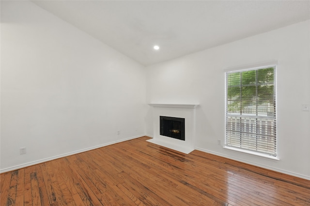 8600 Coppertowne Ln Unit 1305, Dallas, TX 75243 - unfurnished living room featuring a fireplace with flush hearth, wood-type flooring, baseboards, and recessed lighting