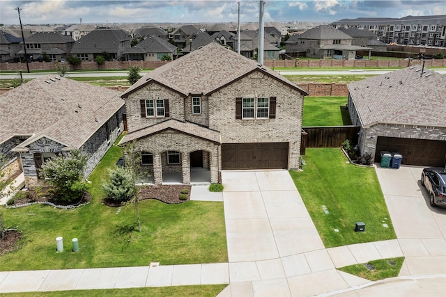 4224 Wood River Trl, Prosper, TX 75078 - french country style house with a residential view, brick siding, concrete driveway, and an attached garage