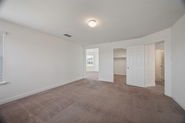 4224 Wood River Trl, Prosper, TX 75078 - unfurnished bedroom featuring carpet, a walk in closet, baseboards, and a closet
