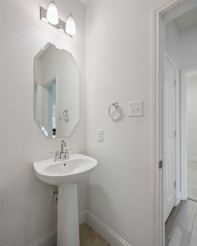 4224 Wood River Trl, Prosper, TX 75078 - bathroom featuring baseboards and a sink