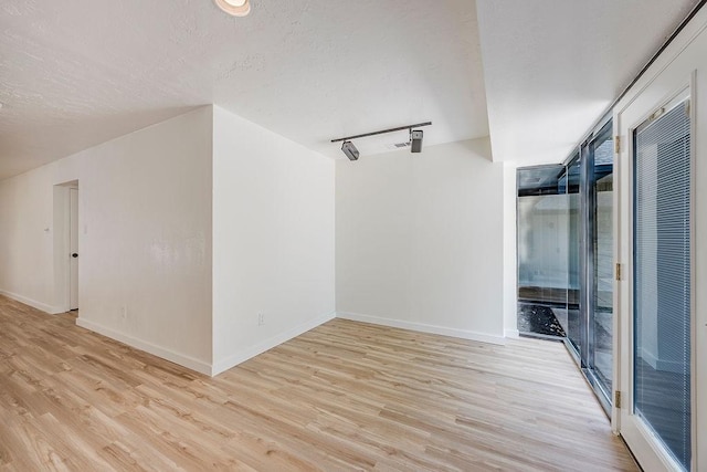 6509 S Hulen St, Fort Worth, TX 76133 - spare room with light wood-type flooring, baseboards, and a textured ceiling