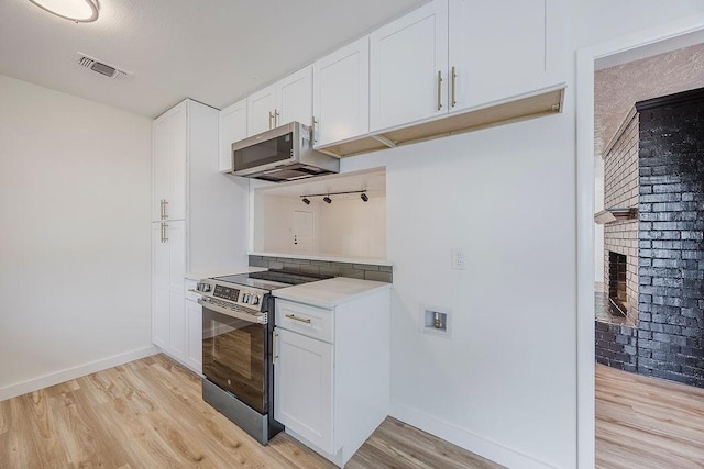 6509 S Hulen St, Fort Worth, TX 76133 - kitchen with appliances with stainless steel finishes, baseboards, light wood-type flooring, and a fireplace