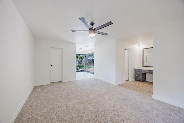 6509 S Hulen St, Fort Worth, TX 76133 - unfurnished living room with light colored carpet, a ceiling fan, and baseboards