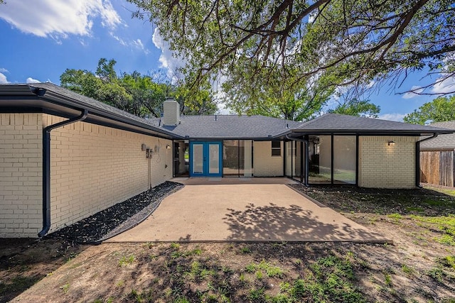 6509 S Hulen St, Fort Worth, TX 76133 - rear view of house with a chimney, a patio area, brick siding, and french doors