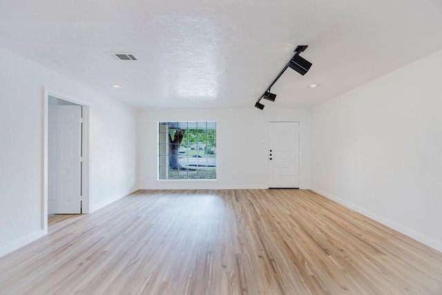 6509 S Hulen St, Fort Worth, TX 76133 - unfurnished living room with light wood-type flooring and baseboards