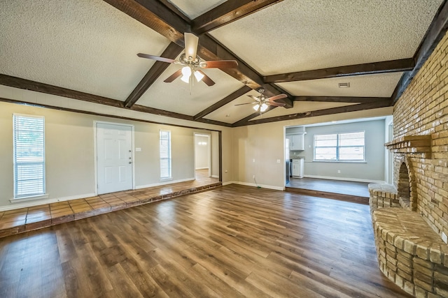 715 San Juan Dr, Duncanville, TX 75116 - unfurnished living room with a textured ceiling, a ceiling fan, wood finished floors, and baseboards