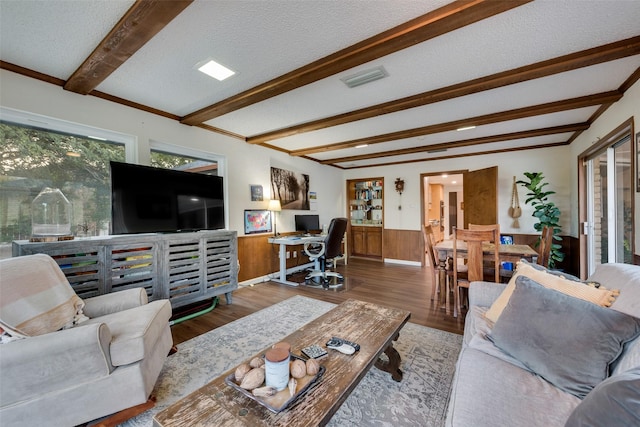 8608 Funtier Ct, Fort Worth, TX 76179 - living area featuring beamed ceiling, a desk, wood finished floors, wainscoting, and a textured ceiling