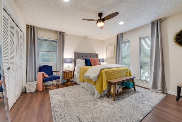 8608 Funtier Ct, Fort Worth, TX 76179 - bedroom featuring wood finished floors, a textured ceiling, a ceiling fan, recessed lighting, and a closet
