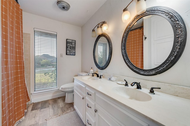 8608 Funtier Ct, Fort Worth, TX 76179 - bathroom with double vanity, wood finished floors, and toilet