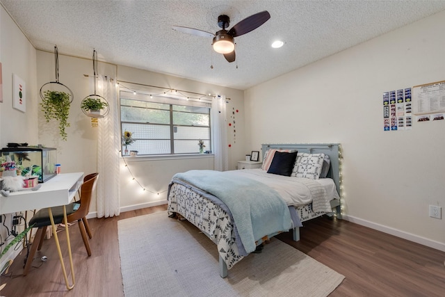 8608 Funtier Ct, Fort Worth, TX 76179 - bedroom featuring wood finished floors, a textured ceiling, baseboards, and a ceiling fan
