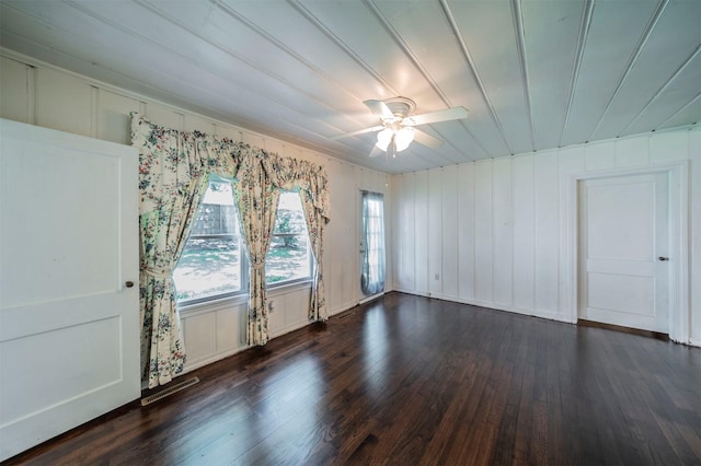 612 W Simmons St, Weatherford, TX 76086 - unfurnished room with dark wood-type flooring, a decorative wall, and a ceiling fan