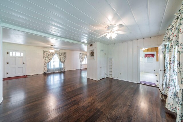 612 W Simmons St, Weatherford, TX 76086 - unfurnished living room featuring a ceiling fan, dark wood-style floors, and baseboards