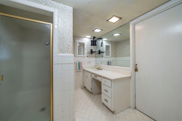 612 W Simmons St, Weatherford, TX 76086 - bathroom with tile patterned flooring, a shower stall, vanity, tile walls, and wallpapered walls