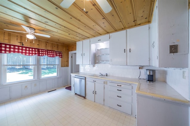 612 W Simmons St, Weatherford, TX 76086 - kitchen featuring a ceiling fan, stainless steel dishwasher, white cabinetry, tasteful backsplash, and wooden ceiling