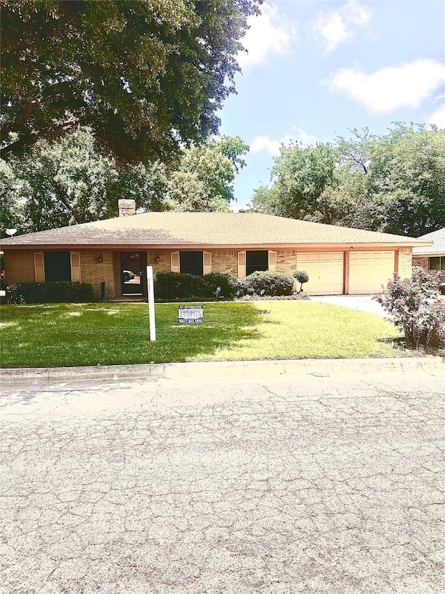 3309 Jamestown Dr, Forest Hill, TX 76140 - ranch-style home with a garage, a front lawn, a chimney, concrete driveway, and brick siding