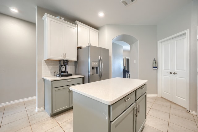 5604 Durst Ln, Forney, TX 75126 - kitchen with stainless steel fridge with ice dispenser, arched walkways, gray cabinets, light tile patterned floors, and recessed lighting