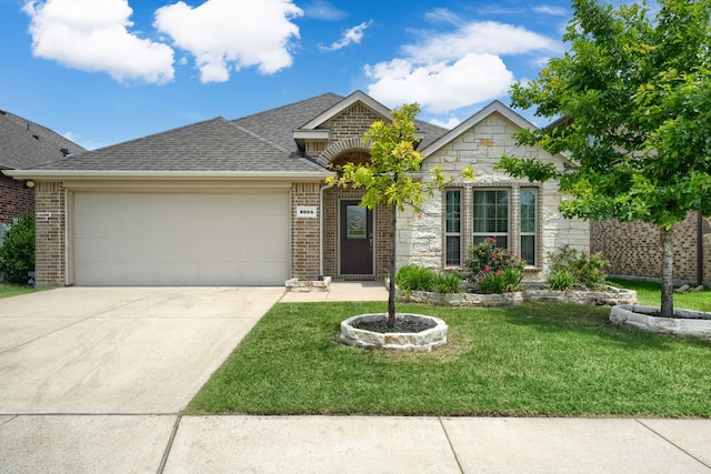 5604 Durst Ln, Forney, TX 75126 - view of front facade with an attached garage, stone siding, a front lawn, concrete driveway, and roof with shingles