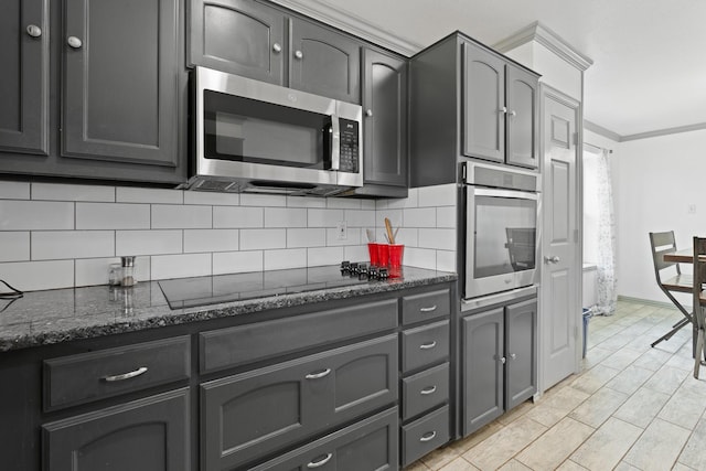 2600 Dave Angel Rd, Burleson, TX 76028 - kitchen with appliances with stainless steel finishes, decorative backsplash, dark stone countertops, crown molding, and gray cabinets