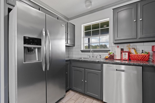 2600 Dave Angel Rd, Burleson, TX 76028 - kitchen with stainless steel appliances, gray cabinets, tasteful backsplash, ornamental molding, and light wood-type flooring