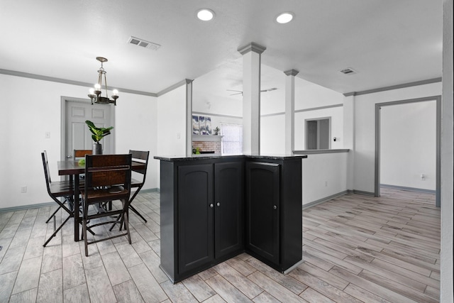 2600 Dave Angel Rd, Burleson, TX 76028 - kitchen featuring light wood-style floors, recessed lighting, dark cabinetry, decorative light fixtures, and crown molding