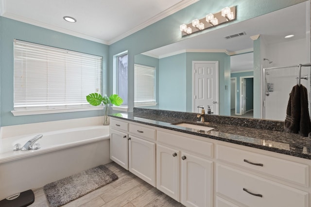 2600 Dave Angel Rd, Burleson, TX 76028 - full bathroom with vanity, a garden tub, wood finished floors, ornamental molding, and a stall shower
