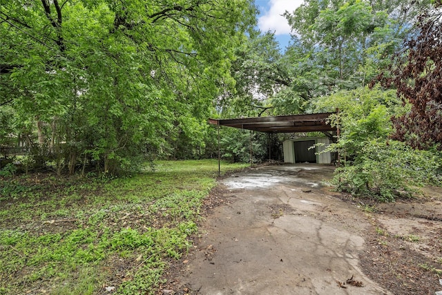 1024 N 45th St, Waco, TX 76710 - view of yard with asphalt driveway and a wooded view