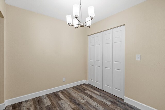 1024 N 45th St, Waco, TX 76710 - unfurnished dining area featuring a chandelier, dark wood finished floors, and baseboards