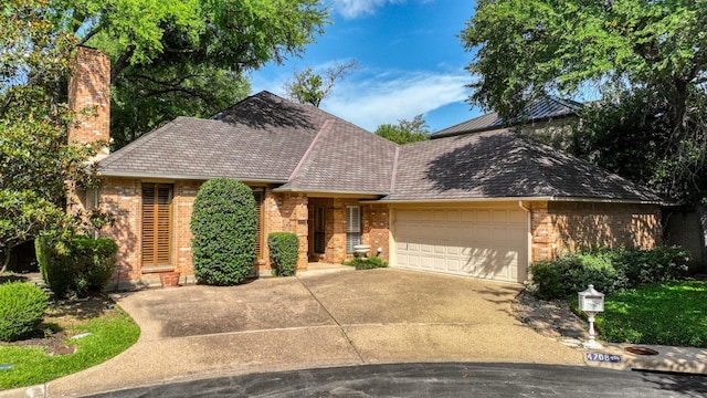 4708 Shady Ridge Ct, Fort Worth, TX 76109 - view of front of home with brick siding, an attached garage, a chimney, and concrete driveway