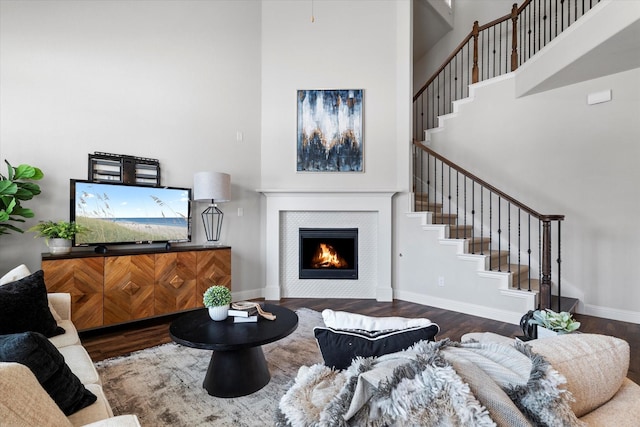 2451 S Gate Dr, Richardson, TX 75080 - living area featuring a high ceiling, wood finished floors, stairs, a tile fireplace, and baseboards