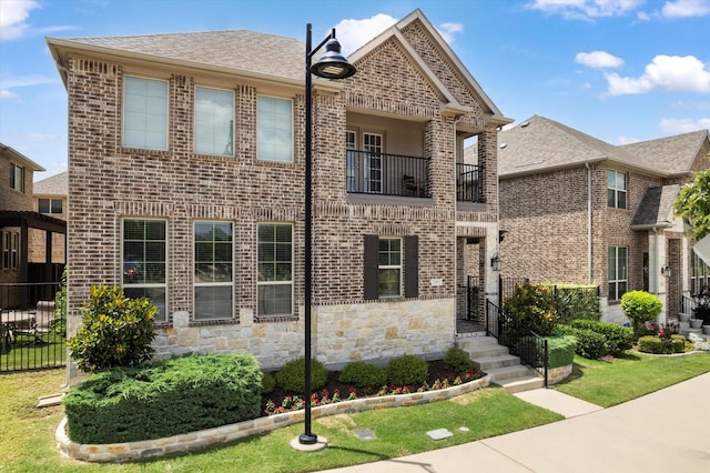 2451 S Gate Dr, Richardson, TX 75080 - view of front of property featuring a balcony, brick siding, and stone siding