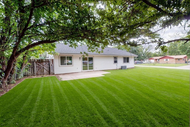 909 Dover Cir, Gainesville, TX 76240 - back of house with a patio, central air condition unit, and roof with shingles