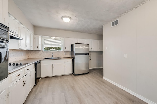 4543 Marigold Trl, Mesquite, TX 75150 - kitchen featuring freestanding refrigerator, dishwashing machine, decorative backsplash, and white cabinets