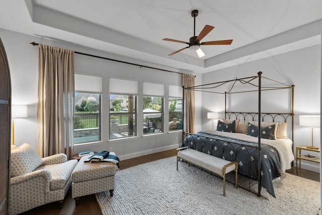 7800 Kentmere, The Colony, TX 75056 - bedroom with a raised ceiling, wood finished floors, baseboards, and a ceiling fan