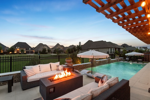 7800 Kentmere, The Colony, TX 75056 - pool at dusk featuring an outdoor living space with a fire pit, a pergola, a patio, and a residential view