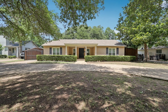 3620 W Biddison St, Fort Worth, TX 76109 - ranch-style home with stucco siding, a gate, a porch, and concrete driveway