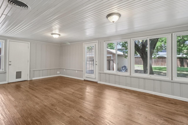 3620 W Biddison St, Fort Worth, TX 76109 - unfurnished living room featuring wood finished floors, healthy amount of natural light, a decorative wall, and baseboards