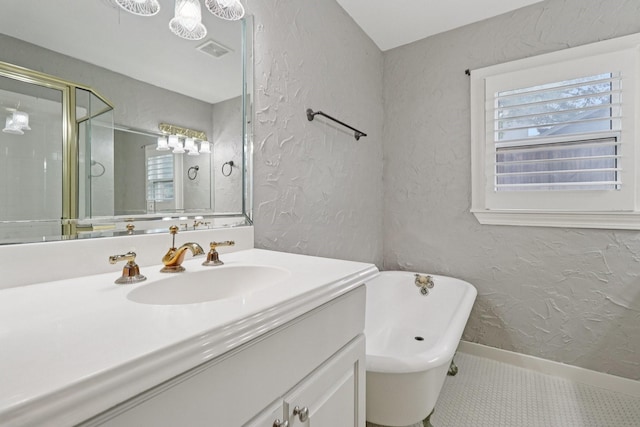 3620 W Biddison St, Fort Worth, TX 76109 - bathroom featuring vanity, a freestanding bath, baseboards, a shower stall, and a textured wall