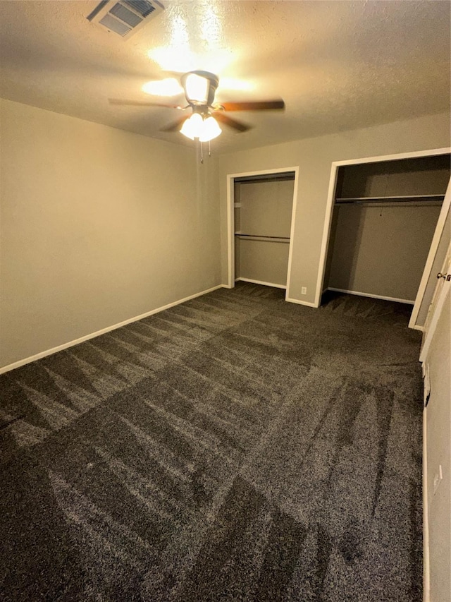 1303 N Morris St, Mckinney, TX 75069 - unfurnished bedroom with multiple closets, carpet flooring, baseboards, and a textured ceiling