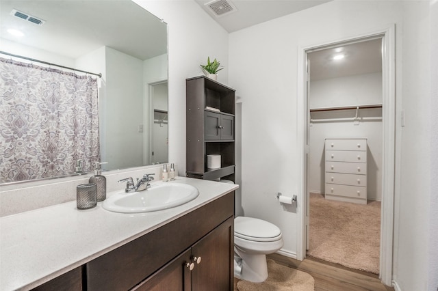 3113 Harper St, Little Elm, TX 75068 - full bath featuring wood finished floors, vanity, toilet, and a walk in closet