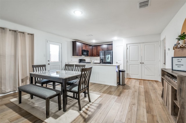 3113 Harper St, Little Elm, TX 75068 - dining space featuring light wood-style floors and recessed lighting