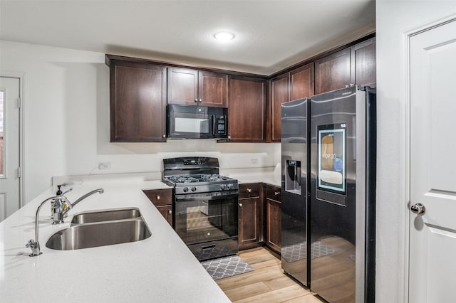3113 Harper St, Little Elm, TX 75068 - kitchen featuring black appliances, a sink, dark brown cabinets, and light countertops