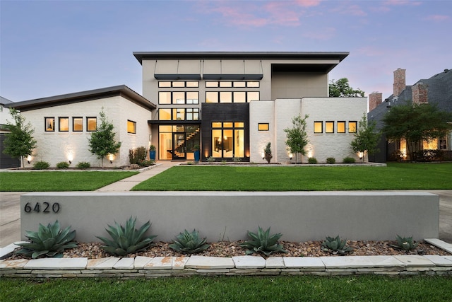 6420 Azalea Ln, Dallas, TX 75230 - back of house at dusk featuring a yard and stucco siding
