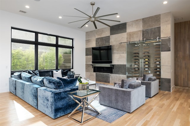 6420 Azalea Ln, Dallas, TX 75230 - living area with light wood-style flooring, recessed lighting, ceiling fan, and a tile fireplace